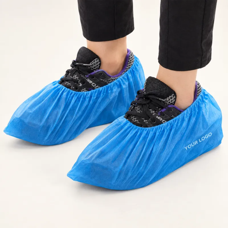 Blue disposable shoe covers worn over trainers